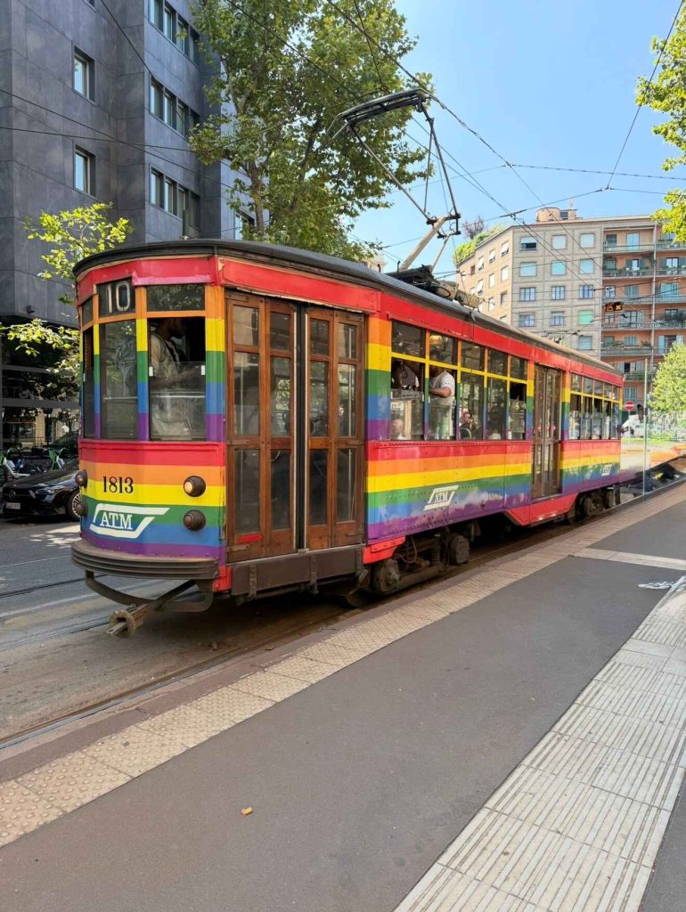 picture of a vintage tram with rainbow colours in Milan