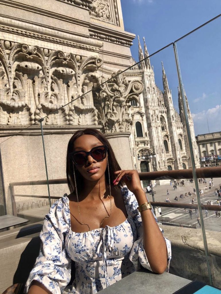 picture of me sitting at a rooftop with the Duomo backdrop
